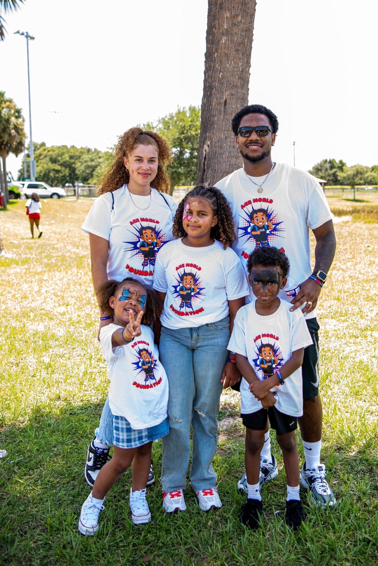 Family in Ace World Foundation shirts